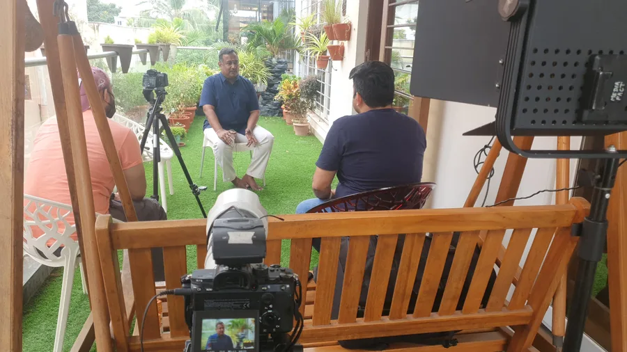 Outdoor founder interview being filmed with lighting and two cameras
