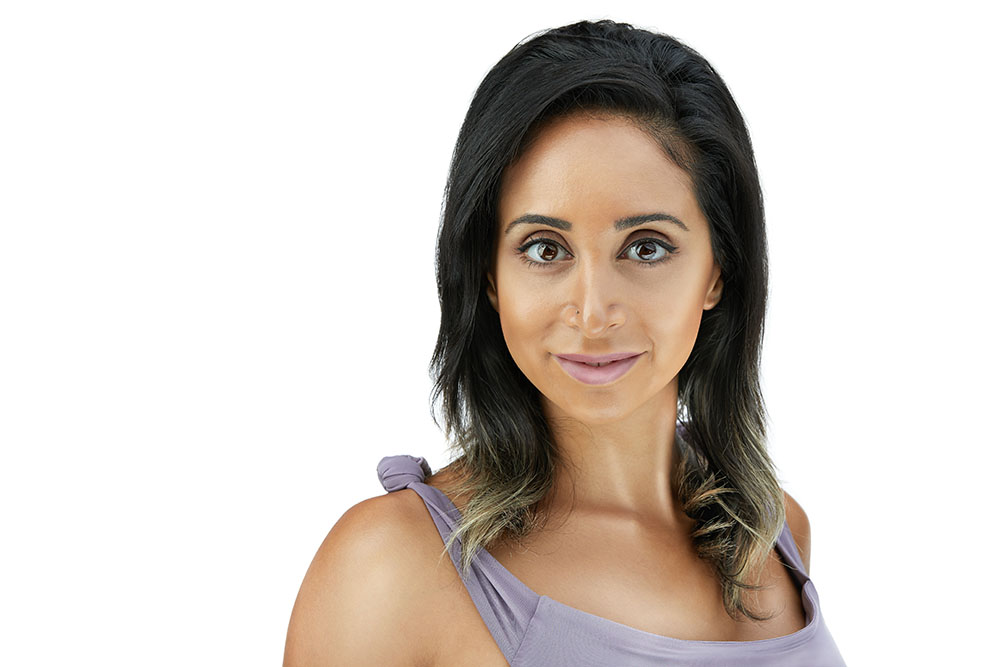 Close-up corporate beauty headshot of a professional woman on a white background